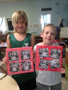 two young children holding up pictures in front of them