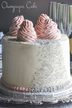 there is a cake with pink frosting on the top and white icing on the bottom