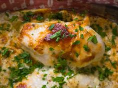 the chicken is covered in cheese and parsley