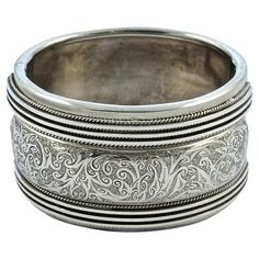 Beautiful Victorian heavy silver bangle, with a lovely engraved raised central panel, and a rope twist and line design to either side. The back has a silky silver sheen. The bracelet tests for silver. It is slightly oval, the inside measurements are 5.7cm / 2.24 inches by 4.9cm / 1.9 inches, and the width is 3.7cm / 1.45 inches. The bracelet is in very good condition, with scratching and some minor indentations as expected. The clasp works well. This is a fabulous heavy antique bangle in a very Luxury Victorian Etched Bracelets, Luxury Hallmarked Antique Silver Bracelet, Luxury Hallmarked Victorian Sterling Silver Bracelet, Victorian Style Silver Engraved Bangle, Victorian Silver Engraved Bangle, Victorian Style Engraved Silver Bangle, Formal Antique Silver Engraved Bangle, Silver Engraved Wide Band Bangle, Victorian Style Silver Engraved Cuff Bracelet