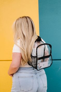 The Jenna Clear Backpack is the perfect choice for both kids and adults thanks to its versatile size and adjustable backpack straps. Featuring a fully-transparent design and front pocket for convenient storage, this clear bag is perfect for school, concerts, or other activities that require security checks. Enjoy all the benefits of a sturdy and secure backpack with peace of mind! Details: 11" long x 11.5" height x 6" wide Mesh side pocket fits up to 16 oz. water bottle Silver hardware 2 exterio Trendy Backpack With Transparent Straps, Trendy School Backpack With Clear Strap, Back To School Travel Backpack With Clear Strap, Back To School Bag With Clear Strap, Clear Backpack For Everyday Use And Back To School, Clear Backpack With Clear Strap For Students, Clear Nylon Backpack With Clear Strap, Trendy Clear Backpack For School, Clear Backpack For Daily Use And Back To School