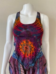 Beautiful blue spiral tie-dye tank top with open crisscross back that you can tie.  One size but is stretchy and the back strings allows you to adjust to fit your body. The front contains two layers and tapers to a V shape. Beautiful and flattering on all body types. Not a crop top!  Perfect for the summer time or for layering!  Comes in 4 different colors! Each top has a unique tie dye pattern. Please inquire if you are interested in the other colors There is dark blue, light blue, gray and rai Fitted Tie Dye Tank Top, Cotton Tie Dye Tank Top For Festivals, Cotton Tie-dye Tank Top For Festival, Fitted Acid Wash Tank Top For Summer, Fitted Tie Dye Hippie Tops, Fitted Hippie Tie Dye Tops, Fitted Tie Dye Tank Top For Festivals, Multicolor Sleeveless Hippie Tank Top, Multicolor Hippie Sleeveless Tank Top