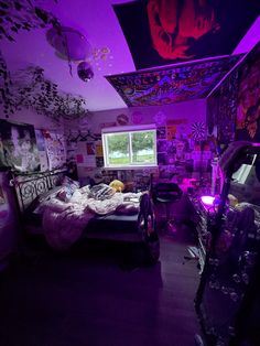 a bedroom with purple lighting and decorations on the walls