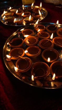 many lit candles are placed on a plate