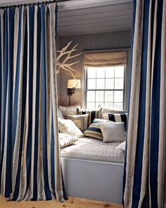 the curtains are open to let in light and airy breeze into this room, along with a bed that has been made up