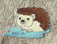 an embroidered hedgehog is sitting in the water