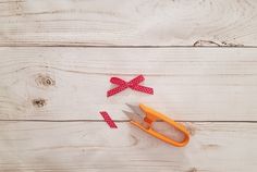 scissors with red polka dot bows on them are laying next to each other and one is cut into smaller pieces