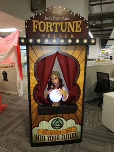 a fortune teller machine in an office cubicle with a woman holding a crystal ball