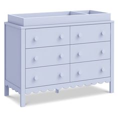 an image of a baby crib with drawers