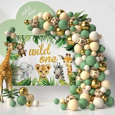 an animal themed birthday backdrop with balloons and jungle animals, including a giraffe