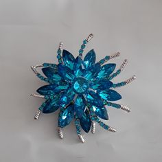 2 1/2 Inch Sparkly Blue Brooch Small Curved Arms With Tiny Ble Stones. Clip On The Back Great Gift Or For Your Self Comes Boxed Blue Costume Jewelry Brooch For Wedding, Blue Crystal Brooch Jewelry, Blue Crystal Jewelry Brooch, Blue Crystal Jewelry With Brooch Detail, Blue Crystal Brooches For Gifts, Blue Brooch For Wedding Jewelry, Blue Wedding Brooch Jewelry, Elegant Blue Brooch For Gift, Elegant Blue Brooch Gift