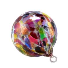 a multicolored glass ball ornament hanging from a hook on a white background