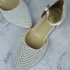 Elevate your style effortlessly with these stunning pearl-embellished flats, designed for the modern woman who values both elegance and comfort. Crafted with meticulous attention to detail, these flats feature a luxurious array of pearls and metallic beads, creating a delicate and sophisticated texture that catches the light with every step. The pointed toe and ankle strap add a touch of femininity and provide a secure, comfortable fit, making these flats perfect for all-day wear. Key Features: Elegant Embellished Flat Ballet Flats, Elegant Embellished Ballet Flats For Formal Occasions, Elegant Embellished Ballet Flats, Elegant Pearl Embellished Flats For Formal Occasions, Elegant Pearl-embellished Formal Flats, Elegant Pearl Embellished Formal Flats, Elegant Embellished Ballet Flats For Party, Elegant Silver Pointed Toe Flats, White Pointed Toe Flats For Evening