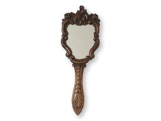 an ornate wooden mirror hanging on the wall next to it's own hand mirror