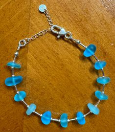 This bracelet is made with genuine sea glass and sterling silver. The sea glass is a lovely shade of blue. Blue Beach, Sea Glass Jewelry, Beach Glass, Sterling Silver Bracelet, Glass Jewelry, Sterling Silber, Beautiful Blue, Columbus, Sea Glass