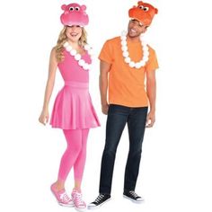 a man and woman in costumes standing next to each other, both wearing pink and orange