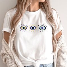 Protect yourself and your loved ones from evil with this pretty evil eye t-shirt! With three styles of eyes in blue, gold and black, it will not only protect you, it will delight you! And it makes a great gift! Please check the size chart to ensure a proper fit. Come check out more Jewish t-shirts and other fun Jewish items at my shop: https://violetbymysidedesign.etsy.com T-Shirt Specs: The soft-style t-shirt puts a new spin on casual comfort. Made from very soft materials, this tee is 100% cot Eye Shirt, Evil Eye Protection, Jewish Gifts, Hanukkah Gifts, Knit Infinity Scarf, Good Fortune, Eye Protection, Soft Style, Twill Tape