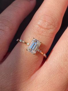 a woman's hand with a diamond ring on it