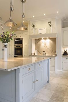 an image of a kitchen with white cabinets and marble counter tops on the phone screen