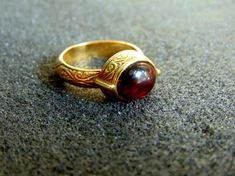 Beautiful women's engraved statement ring. It is made completely out of 18k gold (aka gold 750 each piece is stamped), with a stunning oval garnet stone in its center...------> If you do not know, or you are not sure about your ring size, the ring will be adjustable<----------->A useful guide to help you determine your ring size: http://www.ringsizes.co/ <------ Byzantine Jewelry With Cabochon For Gifts, Byzantine Cabochon Jewelry For Gifts, Byzantine Style Cabochon Jewelry For Gifts, Byzantine Style Cabochon Jewelry Gift, Antique Dome Ring With Polished Finish As Gift, Heirloom Signet Ring With Cabochon As A Gift, Heirloom Signet Ring With Cabochon For Gift, Antique Dome Ring With Polished Finish, Antique Polished Dome Ring Gift