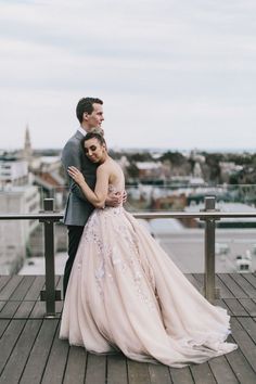 a bride and groom embracing on a balcony