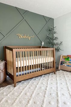 a baby's room with a crib, bookcase and toy bins