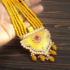 This is a stunning handmade necklace perfect for high end Jewelry Collector, a keeper in Traditional Vintage Indian/Pakistani Bridal jewelry and a Luxury Gift for your Daughter, Sister or Wife on Wedding or Anniversary. Perfect for any type of occasions, weddings And celebrations and a beautiful & memorable gift for weddings and special occasions. -Item Code:- L6059 -Yellow Gemstone Beaded Necklace Set with Earrings. -Designer multi layered faceted Yellow Gemstone beaded necklace. -Gold Plated Set with Kundan Stones which shine like Polki Diamonds. -Metal: Gold plated brass -Earrings are 70mm long & 36mm wide approx -Push Back Earrings -Necklace length with pendant 12" approx excluding adjustable dori/cord -Quantity:- One Necklace Set Please see more different designs here:- https://www.et Luxury Kundan Jewelry In Yellow Gold, Luxury Yellow Gold Kundan Necklace With Meenakari, Luxury Yellow Gold Kundan Necklaces, Yellow Kundan Necklace For Wedding, Traditional Multicolor Gold-plated Kundan Necklace, Multicolor Gold-plated Kundan Necklace Gift, Multicolor Meenakari Gold-plated Necklaces, Necklace Set With Earrings, Pakistani Bridal Jewelry