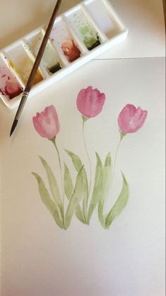 watercolors are being used to paint pink flowers