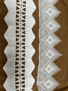 two white crocheted laces on brown fabric, one with an openwork design