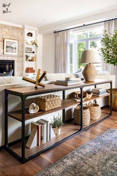 living room console styled with books, baskets, and decor items behind sofa Behind Couch Console, Behind Sofa Console, Behind Couch Decor, Table Behind Sofa, Console Table Ideas, Sofa Table Styling, Decor Console Table, Console Table Behind Sofa, West Of Main