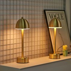 two lamps sitting on top of a white counter