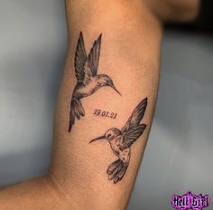 a tattoo with two hummingbirds on it's arm and the word boo written in cursive writing