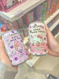 two cans of hello kitty drink in a store