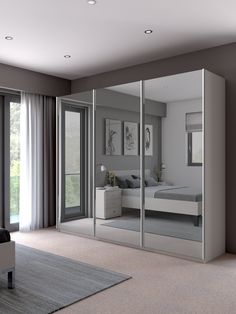 an image of a bedroom with mirrored closet doors and mirrors on the door, which are open to let in lots of light