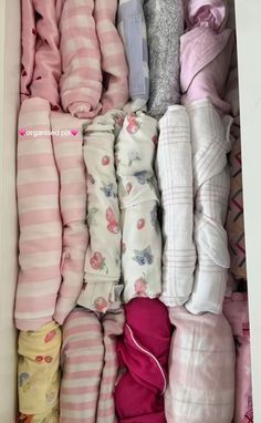 an open box filled with lots of baby clothes