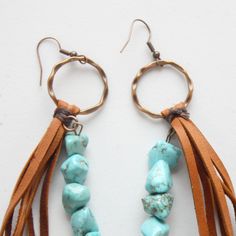 Leather Fringe Earrings with Turquoise Chunks Crafted with love and care, these earrings boast a delightful blend of turquoise beads and genuine leather. The result? A mesmerizing, eye-catching boho look that's bound to turn heads and steal the show!These Leather Fringe Earrings with Turquoise Chunks are the perfect length at approximately 5 inches, striking just the right balance between bold and elegant. They're the ideal statement piece to add that extra oomph to your outfit, whether you're dressing up for a night out or simply expressing your unique boho spirit.Each pair is handmade with a touch of boho magic, making them as unique as you are. So, why settle for ordinary when you can flaunt extraordinary? Elevate your style quotient with our Leather Fringe Earrings and embrace the boho Bohemian Leather Jewelry, Bohemian Beaded Leather Jewelry, Bohemian Leather Earrings, Bohemian Leather Dangle Jewelry, Southwestern Turquoise Earrings With Dangling Beads, Bohemian Turquoise Beaded Earrings With Brass, Bohemian Leather Dangle Earrings, Bohemian Blue Leather Earrings, Blue Bohemian Leather Earrings