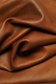 a brown leather textured up close to the surface