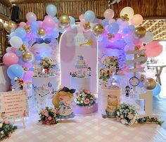 a table topped with lots of balloons and decorations