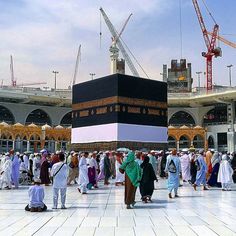 a group of people standing around a large building