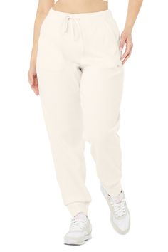 Total live-in material. The Muse Sweatpant takes comfort seriously—it’s made with a soft ribbed knit and has a relaxed silhouette, drawstring closure and pockets at side and back. Wear it with the matching hoodie or an easy tank. An iconic Alo fave So comfy & all-day cute Designed & uniquely fit to flatter every size Wear-tested by our in-house team for the perfect fit Muse Sweatpant in Ivory, Size: Large | Alo Yoga® Casual Ribbed Sweatpants For Loungewear, Comfy Ribbed Bottoms, Relaxed Fit Off White Bottoms For Loungewear, Comfortable Ribbed Sweatpants For Loungewear, Ribbed Athleisure Bottoms For Lounging, Athleisure Ribbed Lounging Bottoms, Ribbed Sweatpants For Fall Loungewear, White Ribbed Bottoms For Fall, Casual Ribbed Cotton Sweatpants