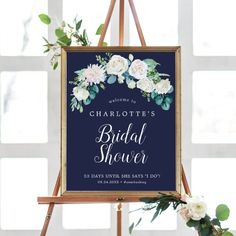 a sign that says charlotte's bridal shower on it next to some flowers