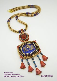 "Buried loot of the ancients is fascinating, Egyptian jewelry in particular. Brightly colored lapis lazuli, carnelian, turquoise, amethyst, peridot and other gemstones set in shiny gold surrounded by more ornamentation in enamel is proof that ancient Egyptians loved colorful jewelry. Scarabs symbolized immortality. Bastet, a cat, protected women from diseases and majestic Sphinx were carved in gemstones and used in jewelry. Buried Treasure Necklace features a beautiful Czech glass button with Sp Spiritual Gemstone Beads Jewelry For Celebration, Traditional Gold Jewelry With Cabochon, Traditional Gold Cabochon Necklaces, Gold Cabochon Round Beads Jewelry, Artisan Gold Necklace With Cabochon, Collectible Gold Jewelry With Natural Stones, Gold Jewelry With Natural Stones For Collectors, Gold Bohemian Beads For Jewelry Making, Artisan Gold Lapis Lazuli Jewelry