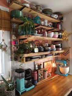 shelves filled with bowls and plates on top of a wooden counter