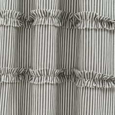 the ruffles on this curtain are striped in black and white, with stripes