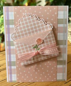 a close up of a greeting card on a wooden table with flowers and laces