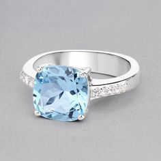 "Blue Topaz Ring, Natural Sky Blue Topaz Cushion Cocktail Ring, Sky Blue Topaz Silver Ring, December Birthstone Ring, Topaz Birthstone Ring Flaunt yourself with this blue & white topaz cocktail ring. The natural gemstones have a combined weight of 4.62 carats and are set in .925 sterling silver with rhodium plating. The soft blue hue of this ring adds a pop of color to any look! The understated design and vibrant stones make this ring perfect for every occasion. .925 Sterling Silver Stone De Blue White Topaz Ring With Gemstone, Blue White Topaz Ring For Promise, Blue Topaz Crystal Ring With Gemstone Accents, Blue White Topaz Ring As A Gift, Blue White Topaz Ring As Gift, Blue White Topaz Ring Gift, Blue White Topaz Ring, Blue Topaz Ring With Gemstone Accents, Blue Topaz Ring With Accent Stones