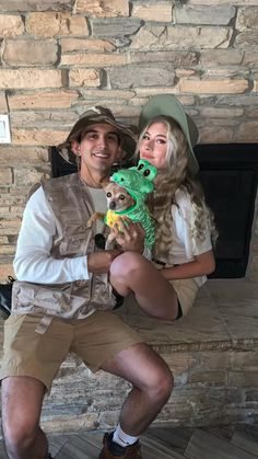 a man and woman sitting on a bench holding a stuffed animal