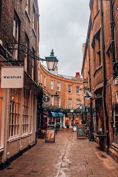 an alley way with buildings and shops on both sides