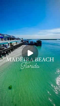 the water and beach in front of some buildings with words that read madera beach florida