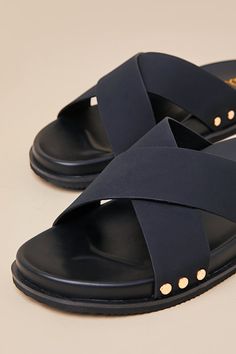 The Lulus Sevyn Black Studded Slide Sandals are essential for looking trendy all season long! These stylish summer sandals are composed of smooth faux leather that shapes an almond-shaped footbed and wide, crisscrossing vamp straps adorned with shiny gold studded details at the sides. A contoured insole completes the sleek and simple slide-on design. 0. 25" foam sole. Smooth insole. Foam sole has nonskid markings. Man made materials. Imported. Lulus | Sevyn Black Studded Slide Sandals | Size 6.5 Chic Sandals With Crisscross Straps And Open Toe, Chic Cross Strap Sandals For Vacation, Chic Crossover Sandals For Summer, Chic Crossover Sandals For Spring, Chic Crossover Spring Sandals, Spring Cross Strap Footbed Sandals With Textured Footbed, Summer Leather Footbed Sandals With Cross Strap, Leather Footbed Sandals With Cross Strap For Summer, Spring Textured Footbed Cross Strap Sandals